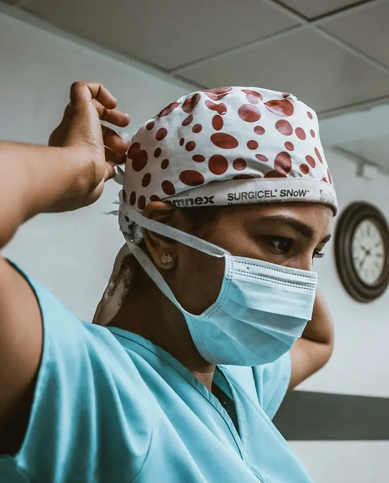 Nurse putting on PPE