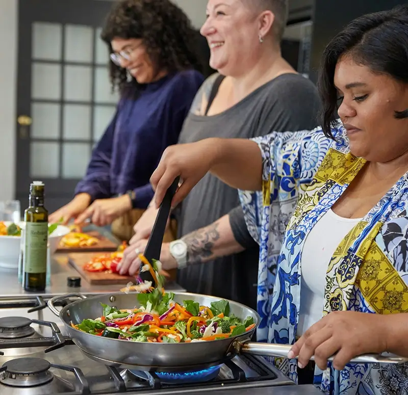 Women smiling during cooking class