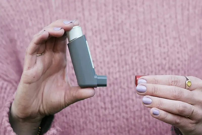 Woman holding inhaler