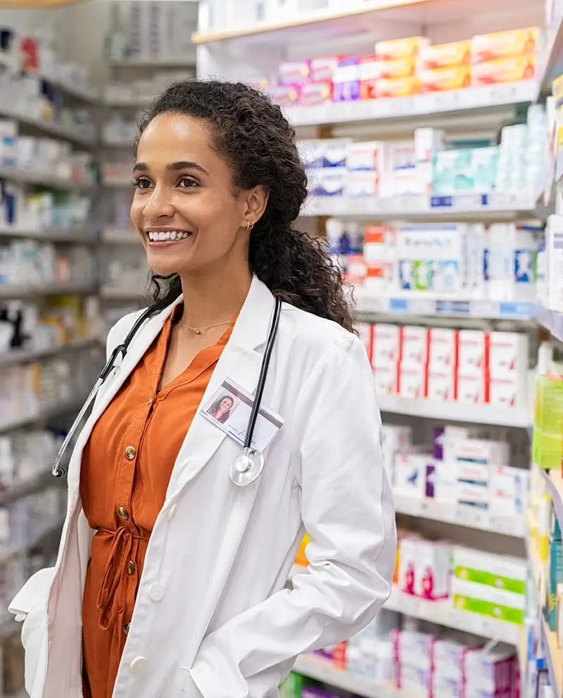 Smiling doctor in pharmacy