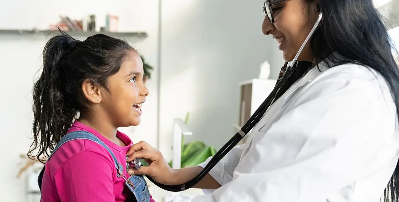 Doctor and young girl smiling during appointment