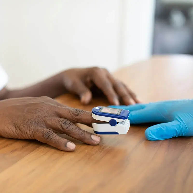 Professional checking patient's blood oxygen levels